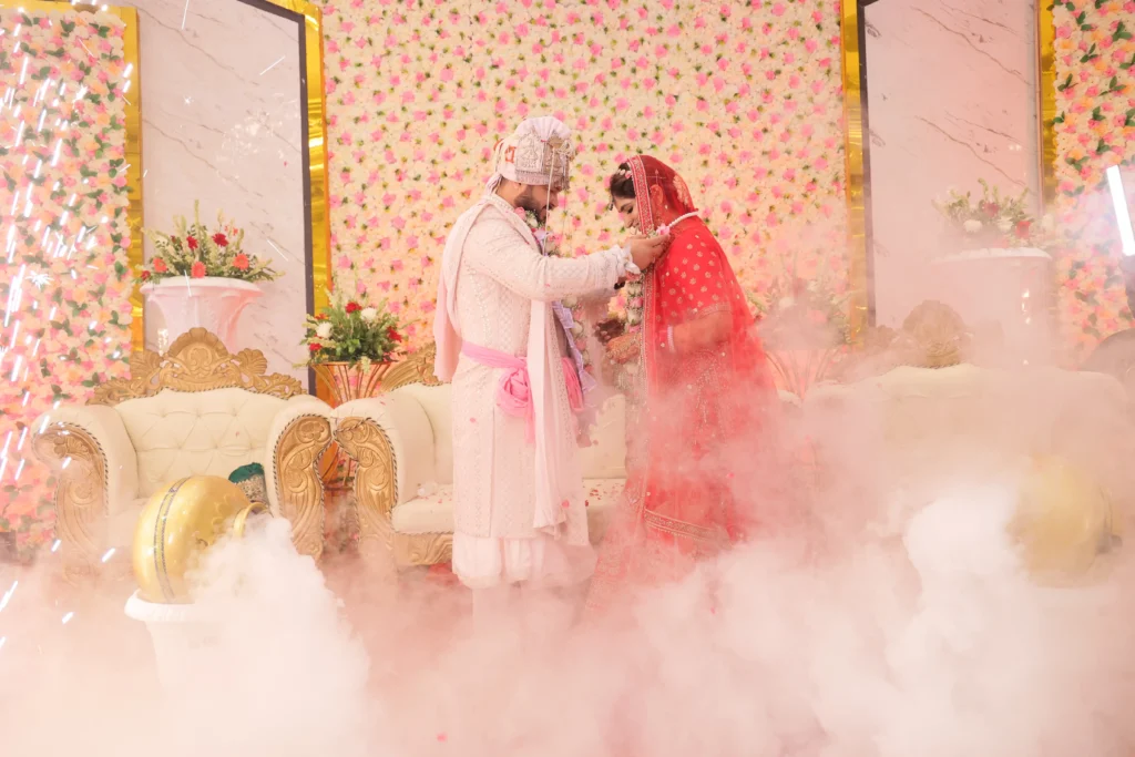 bride and groom in jaimala ceremony captured by our top wedding photographer in delhi